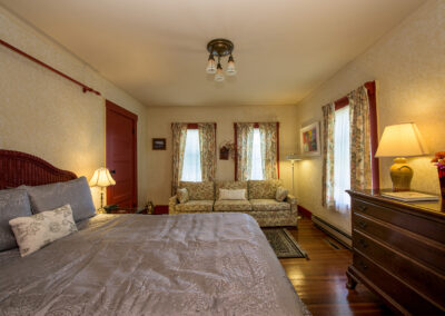 king bed in room 1 light walls red trim