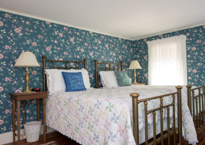 two single beds in room 4, blue wallpaper