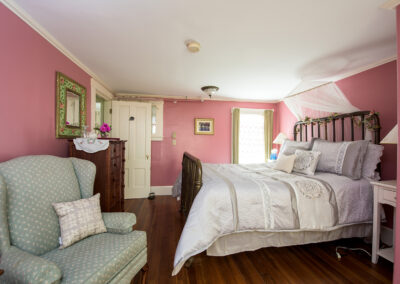 double bed in room 5, pink walls